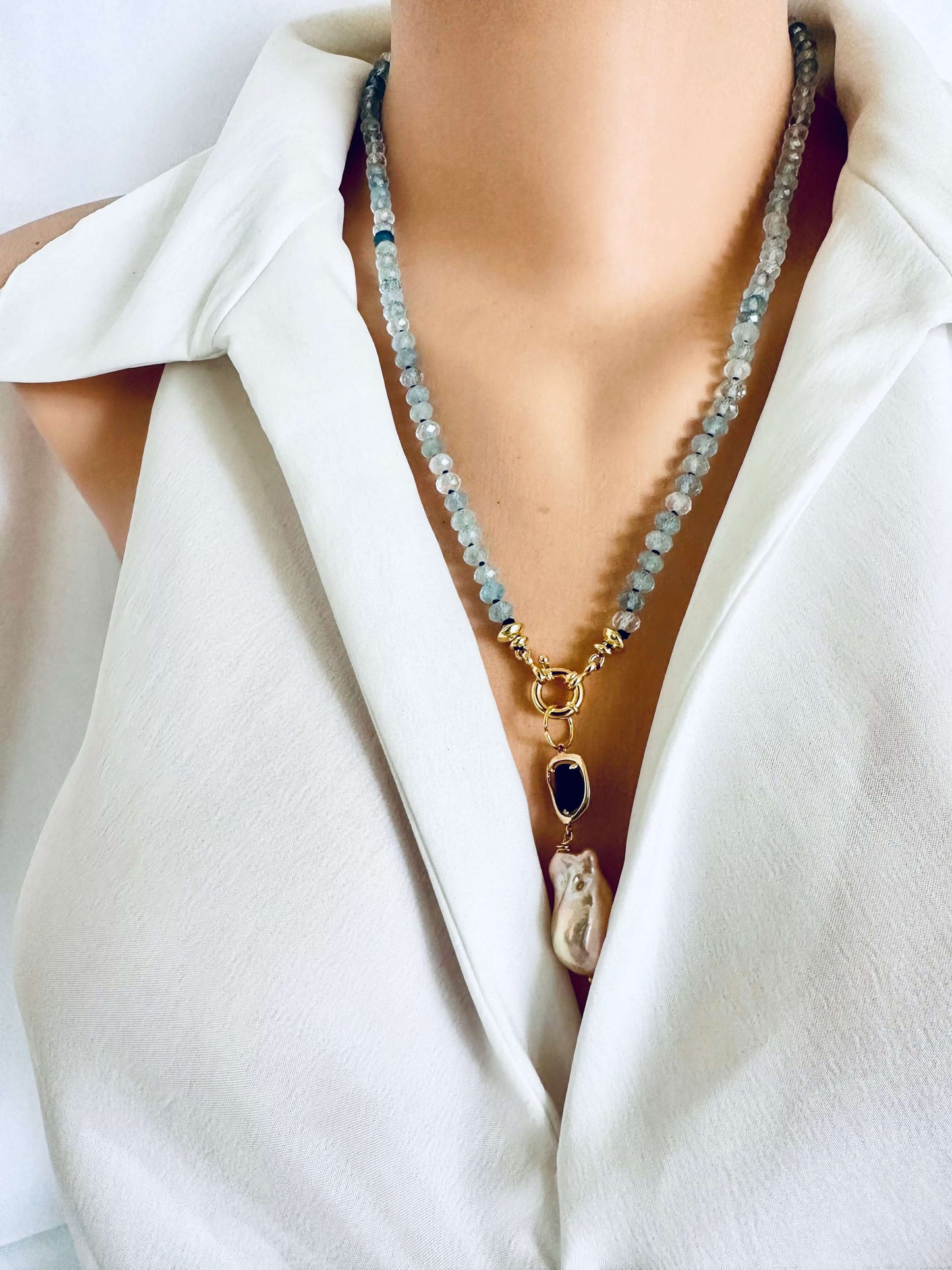 Aquamarine baroque pearl necklace featuring blue aquamarine beads and a luminous baroque pearl pendant.