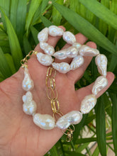 Load image into Gallery viewer, Handcrafted baroque pearl gold chain necklace photographed outdoors with leafy green background — natural light lifestyle jewelry photo by Loulia Pearl Jewelry