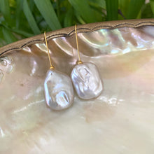 Carica l'immagine nel visualizzatore di Gallery, White freshwater pearl drop earrings gold vermeil version resting on shell with green foliage, handcrafted in Canada.