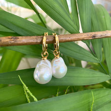Carica l'immagine nel visualizzatore di Gallery, White Baroque Pearl Earrings – gold dangle design shown on green leaf background
