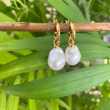 Carica l'immagine nel visualizzatore di Gallery, White Baroque Pearl Earrings – close-up against green leaf background