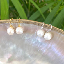 Load image into Gallery viewer, Button Pearl Earrings – gold and silver sets dangling from pearl shell and green leaves