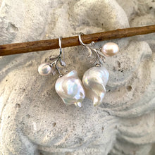 Load image into Gallery viewer, Close-up of baroque pearl earrings in silver with rose leaf design on white background