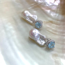 Load image into Gallery viewer, Blue topaz pearl drop earrings displayed on white pearl shell background
