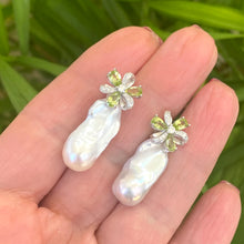 Load image into Gallery viewer, Handcrafted Peridot stud earrings with baroque pearl drops held in hand