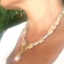 Load image into Gallery viewer, Golden baroque pearl toggle necklace worn by woman — luminous handcrafted statement jewelry with gold details by Loulia Pearl Jewelry