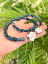 Load image into Gallery viewer, Blue apatite coral pearl necklace held in hand against leafy green backdrop — colorful handcrafted gemstone jewelry by Loulia Pearl Jewelry