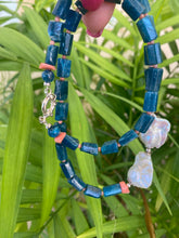 Load image into Gallery viewer, Blue apatite coral pearl necklace displayed against green leaves — natural light photo of handcrafted gemstone and pearl jewelry