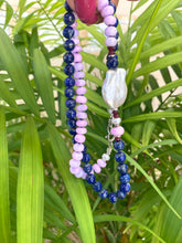 Load image into Gallery viewer, Lapis lazuli and baroque pearl necklace displayed against green leaf backdrop, handcrafted gemstone jewelry.