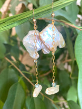 Load image into Gallery viewer, Close-up of boho pearl earrings gold filled photographed with green leaves — natural light jewelry shot showing blue topaz accent stones