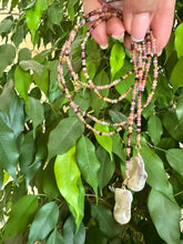 Load image into Gallery viewer, Multi Tourmaline Baroque Pearl Lariat Necklace held against green leaves — natural gemstone and pearl jewelry handcrafted by Loulia Pearl Jewelry