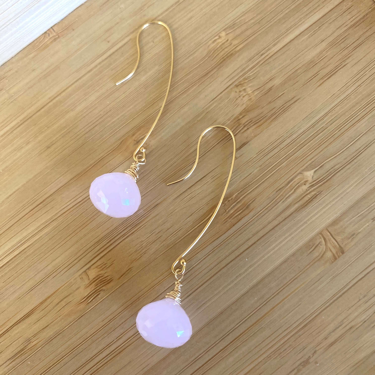 Rose quartz threader earrings with briolettes showcasing a delicate design and blush-pink tones.