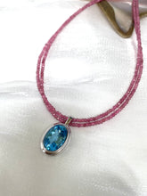Load image into Gallery viewer, Pink Tourmaline Blue Topaz Pendant | Double Strand Design by Loulia Pearl Jewelry on elegant fabric.