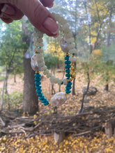 Load image into Gallery viewer, Detail view of handmade green jade and turquoise pearl necklace near leaves