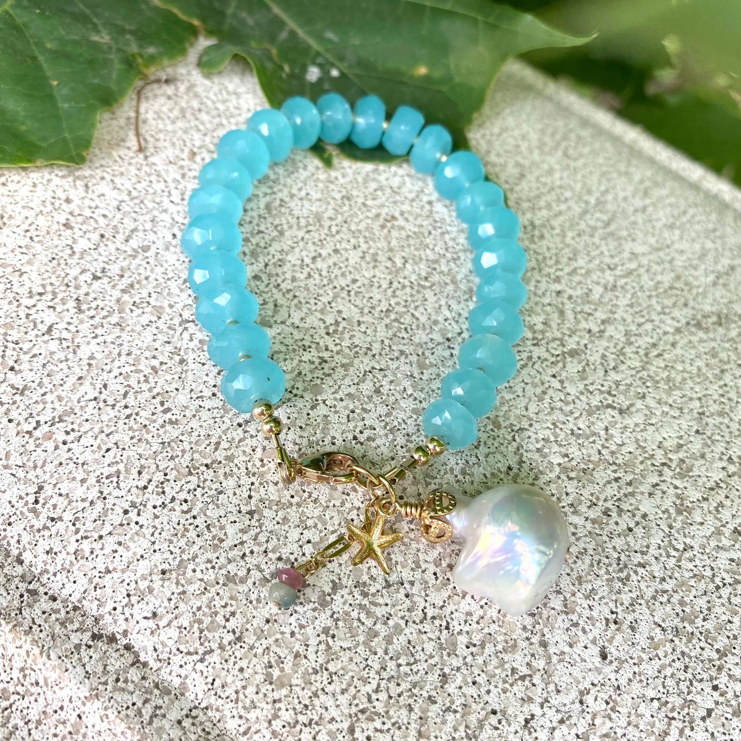 Chalcedony bracelet with starfish and baroque pearl charm, featuring aqua blue rondelle beads and elegant details.