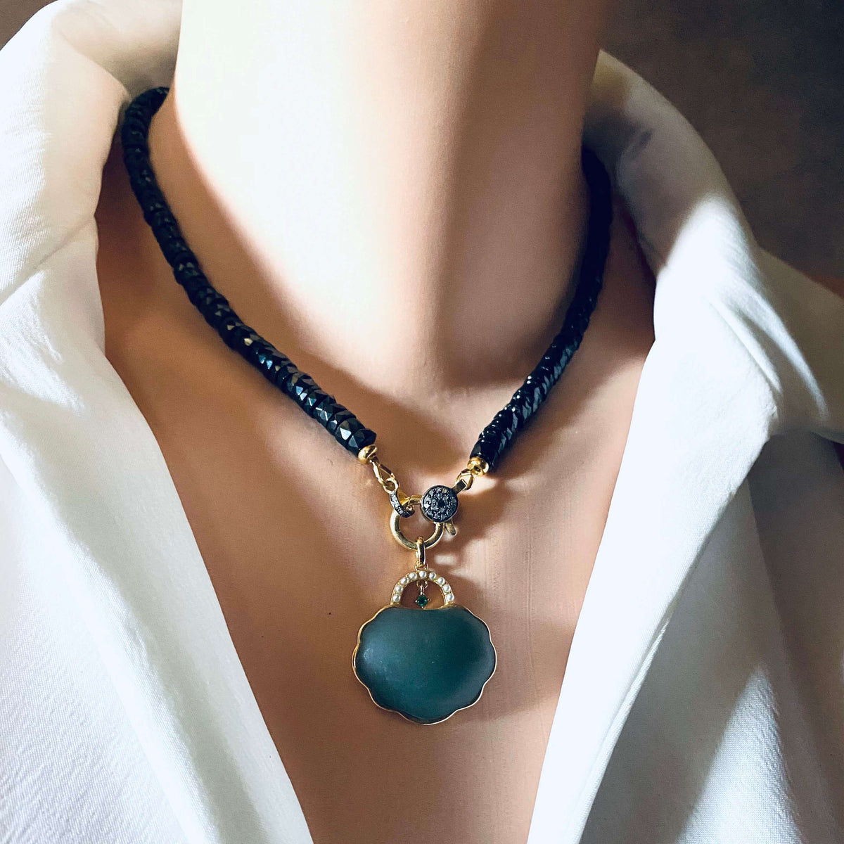 Black spinel beaded necklace with gold vermeil pavé clasp, showcasing elegance and modern luxury.