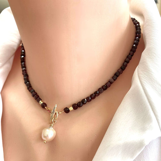 Garnet toggle necklace featuring faceted garnet cube beads and a baroque pearl charm for elegant style.
