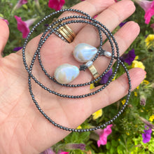 Load image into Gallery viewer, Hematite and pearl beaded lariat Y necklace featuring a single strand of tiny hematite beads, adorned with a hematite star and a baroque pearl at each end. In 27 to 32 inches, this elegant and versatile necklace adds a unique touch to any outfit.