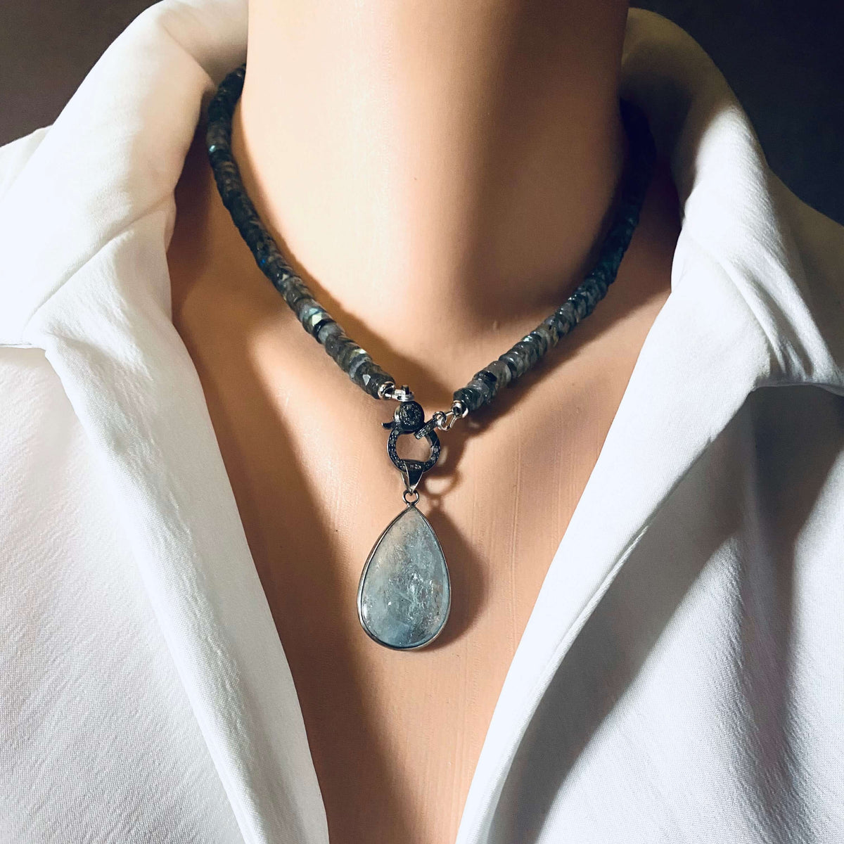 Labradorite beaded necklace with oxidized silver pavé clasp showcasing elegant design and shimmering facets.