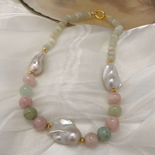 Morganite and jade necklace with baroque pearls displayed on white fabric, showing soft pink silk thread and gold vermeil clasp.