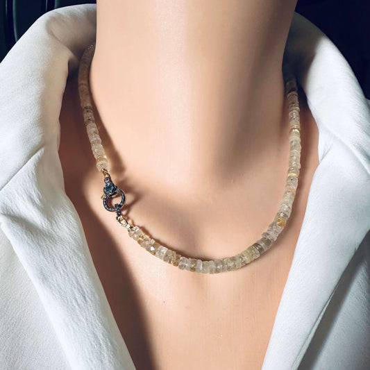 Rutilated quartz gemstone necklace with oxidized vermeil pavé clasp displayed on a mannequin.
