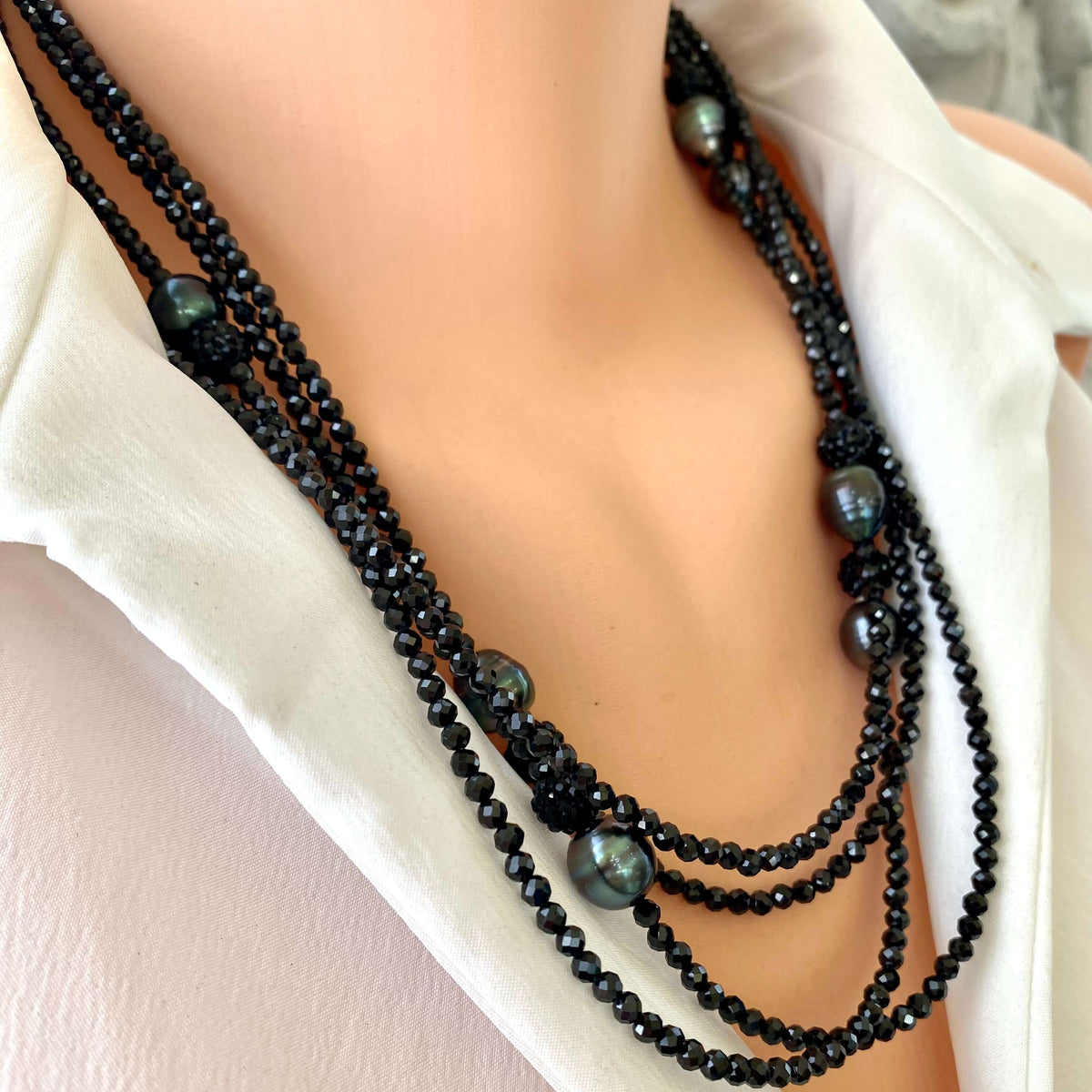 Black spinel pearl necklace worn on mannequin, front close-up