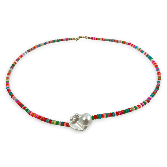 A beaded necklace featuring a vibrant mix of red, green, blue, pink, and yellow beads, with a central silver heart-shaped charm and a gold clasp, shown on a plain white background.