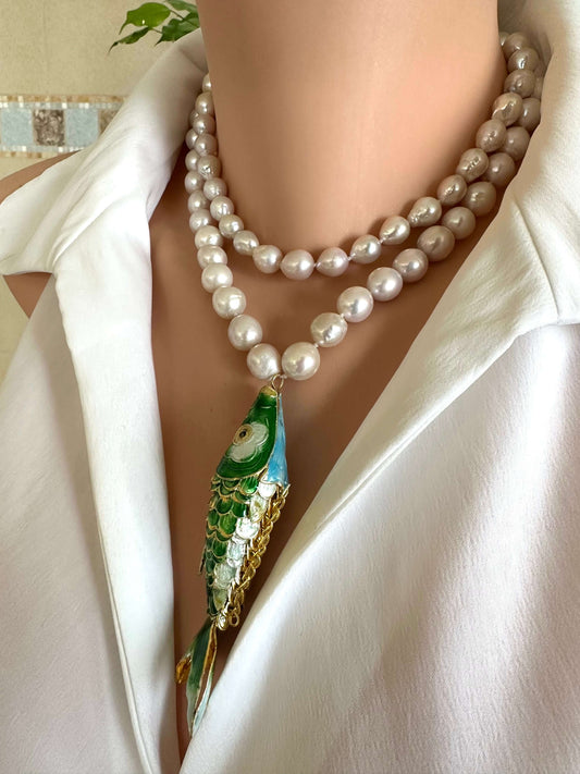 Cloisonné fish pearl necklace with hand knotted baroque pearls displayed on a mannequin wearing a white shirt.