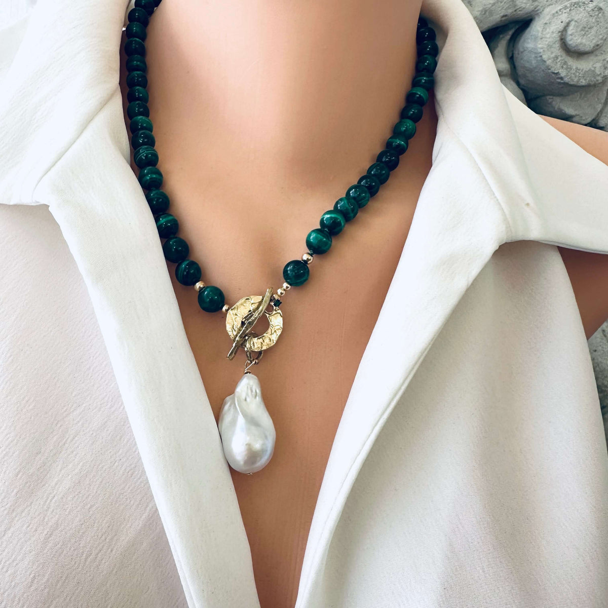 Malachite toggle necklace with baroque pearl pendant, showcasing artisan craftsmanship and natural beauty.