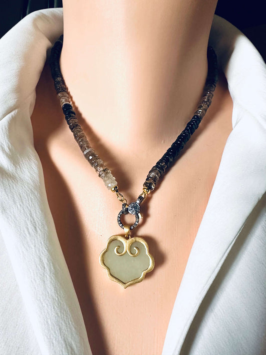 Hotan jade pendant in gold vermeil with natural nephrite charm, displayed on a decorative necklace.