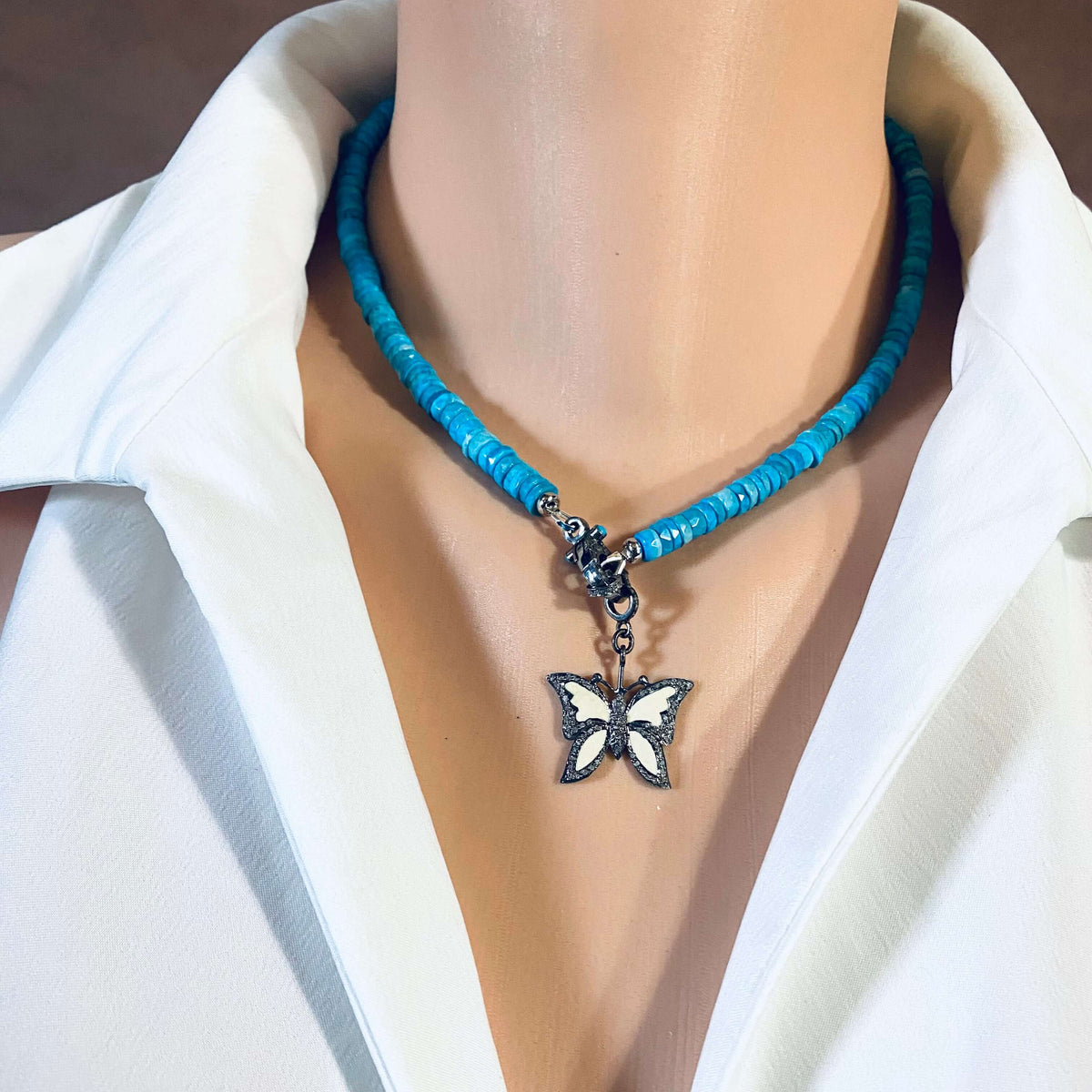 Turquoise Howlite Beaded Necklace with Oxidized Silver Pavé Clasp worn on a mannequin's neck.