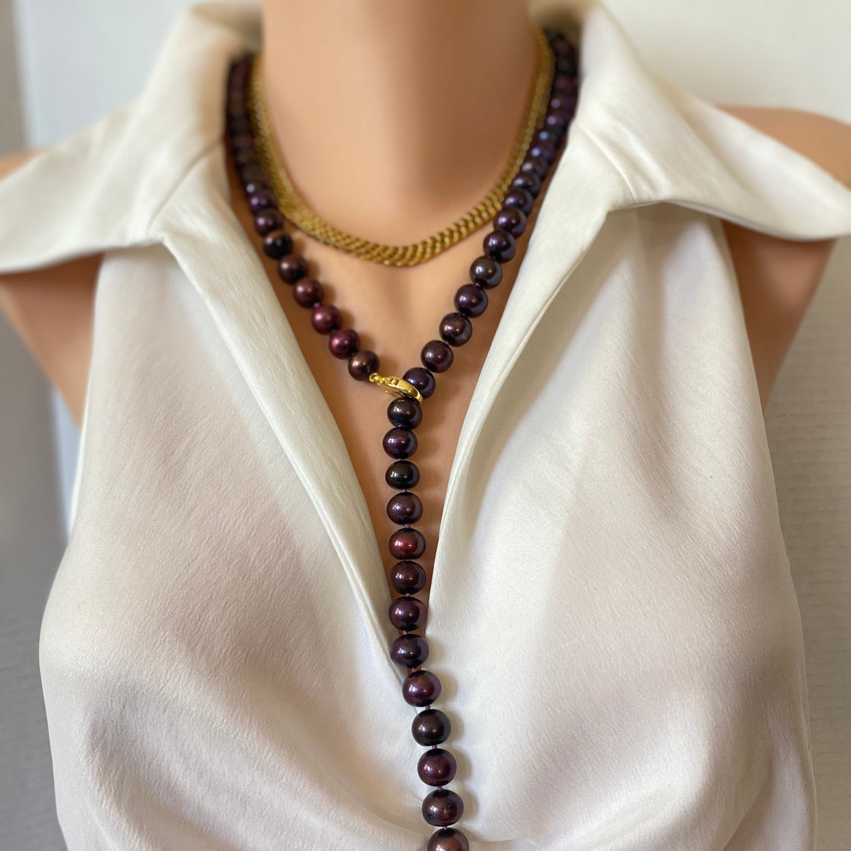 red burgundy pearl y necklace layered with a gold chain