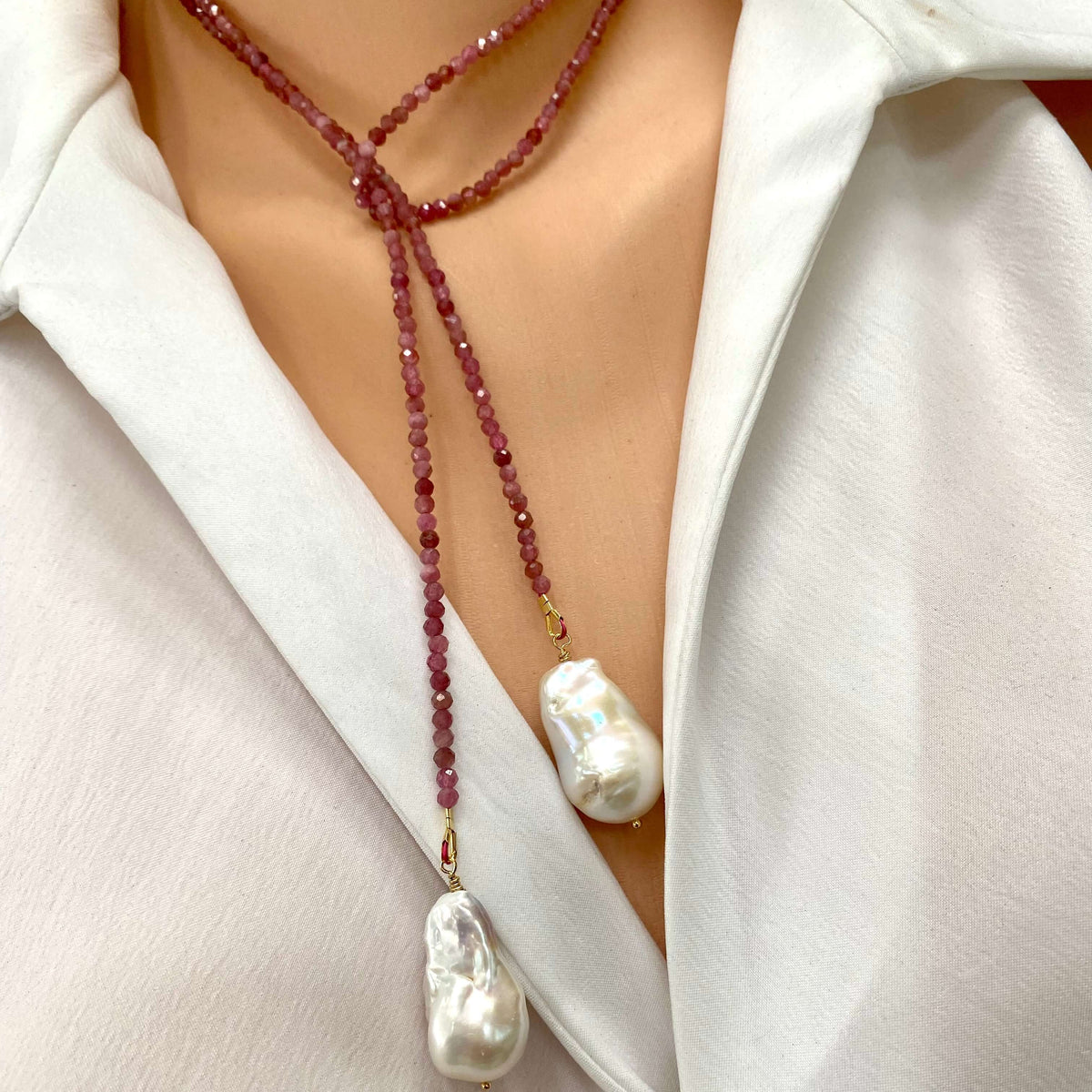 Pink Tourmaline Pearl Lariat Necklace featuring pink tourmaline beads and white baroque pearls, worn elegantly.