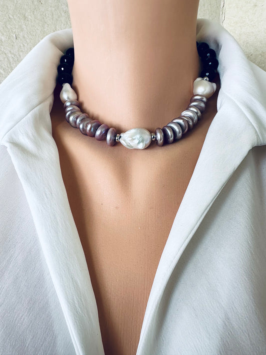 Baroque pearl necklace with black tourmaline and white pearls worn at collarbone