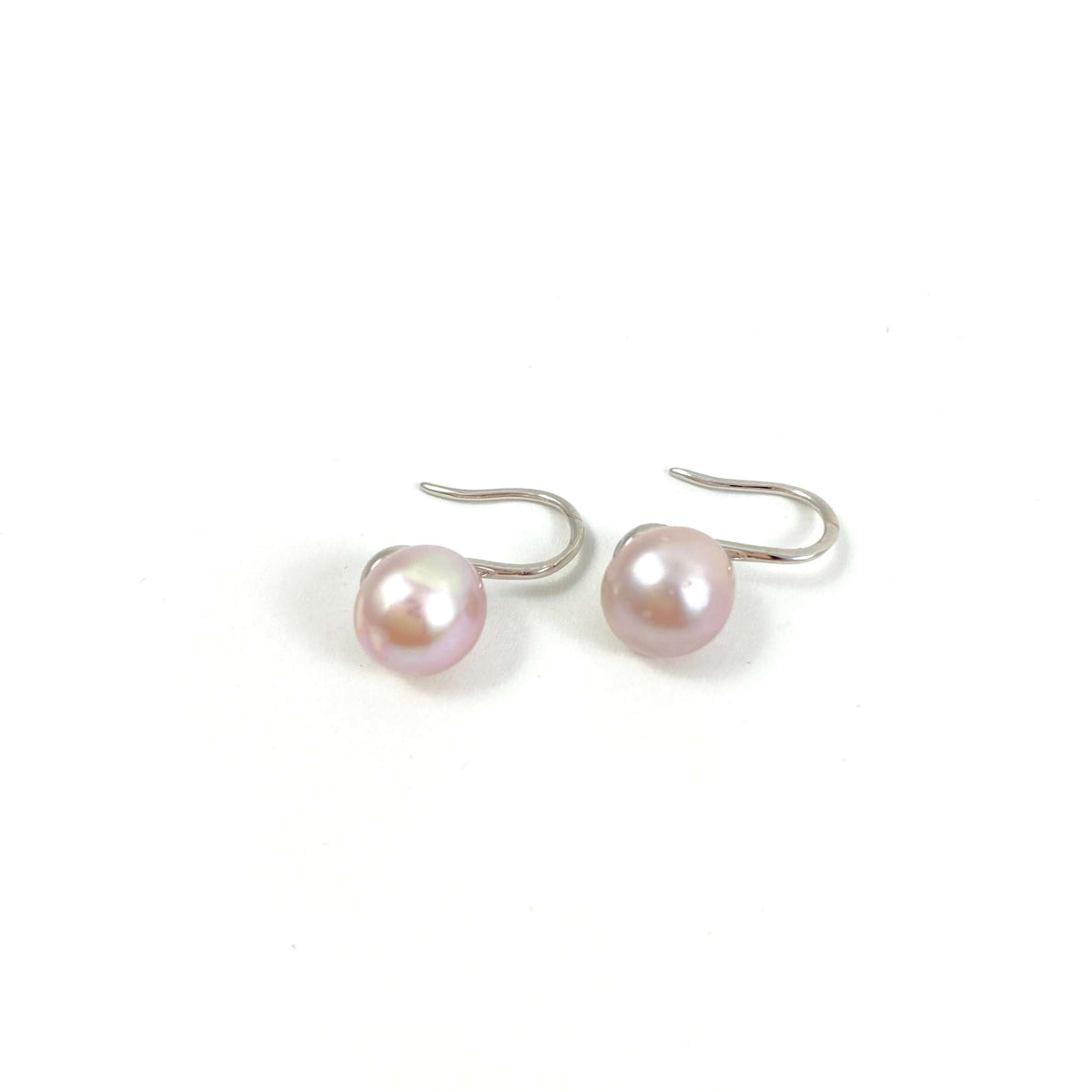 silver high heel earrings with pink pearls on white background