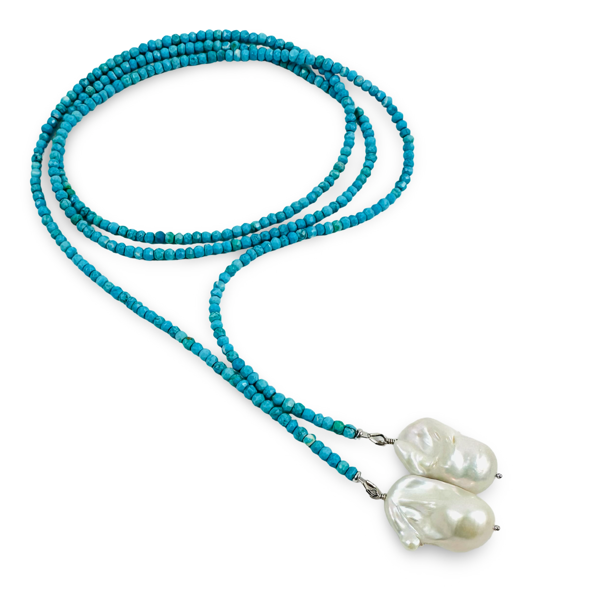 A long beaded necklace featuring vibrant turquoise blue beads and two large, irregular white baroque pearls at the ends, displayed on a clean white background.