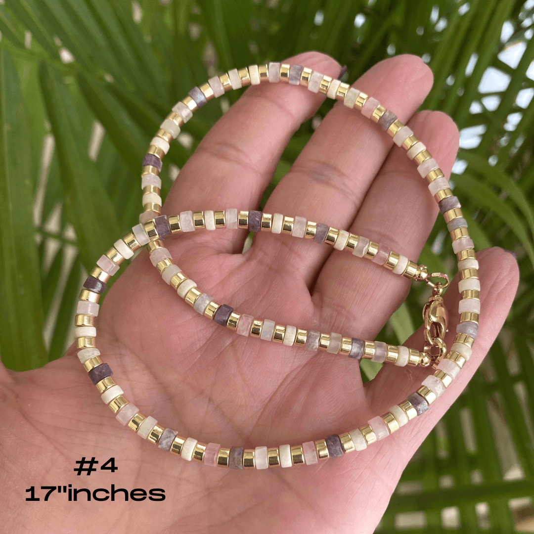 Gemstone choker necklace with multi color beads and hematite displayed on hand, measuring 17 inches.