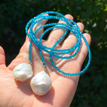 Load image into Gallery viewer, Single strand lariat necklace featuring faceted London blue quartz beads 3mm and two large baroque pearls, measuring 43 inches. This elegant piece is perfect as a December birthstone gift for her.