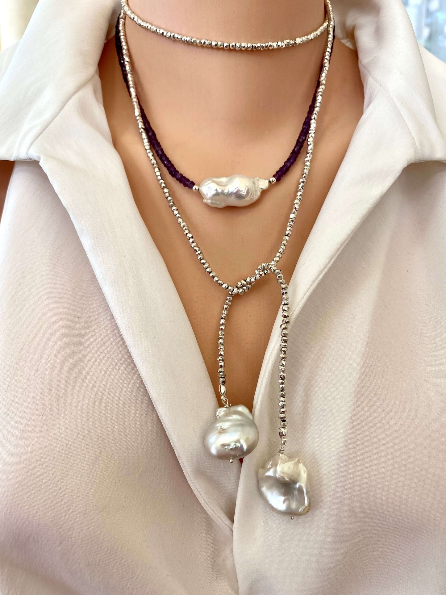 Amethyst baroque pearl necklace styled as a statement piece with large freshwater pearl
