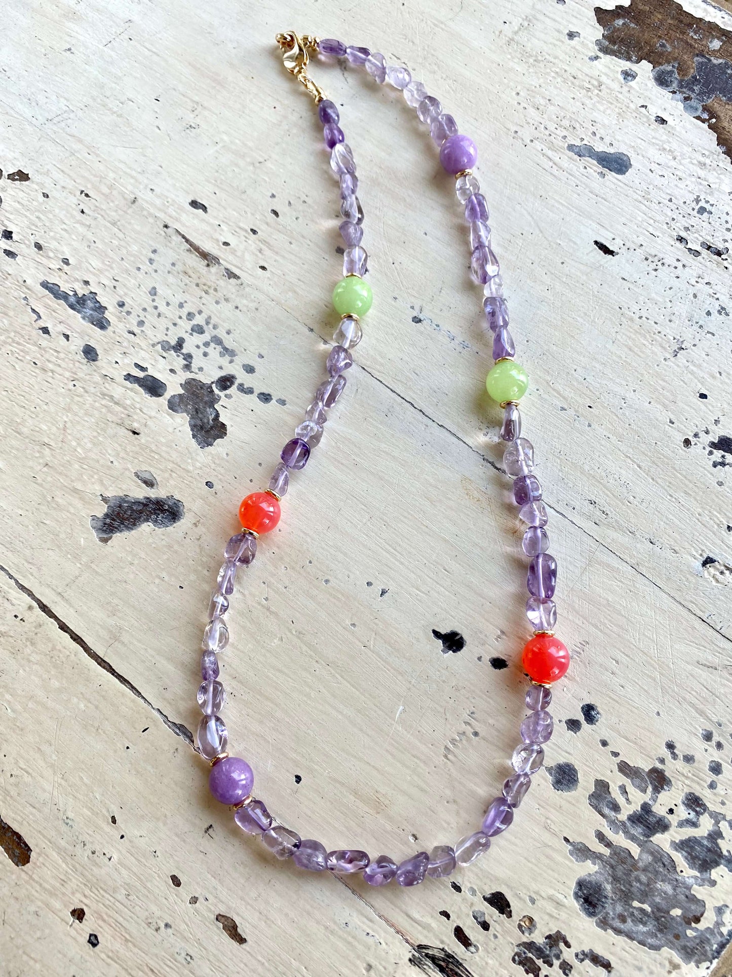Amethyst gemstone necklace flat lay, bonbons multigem necklace with amethyst, quartz and jade beads