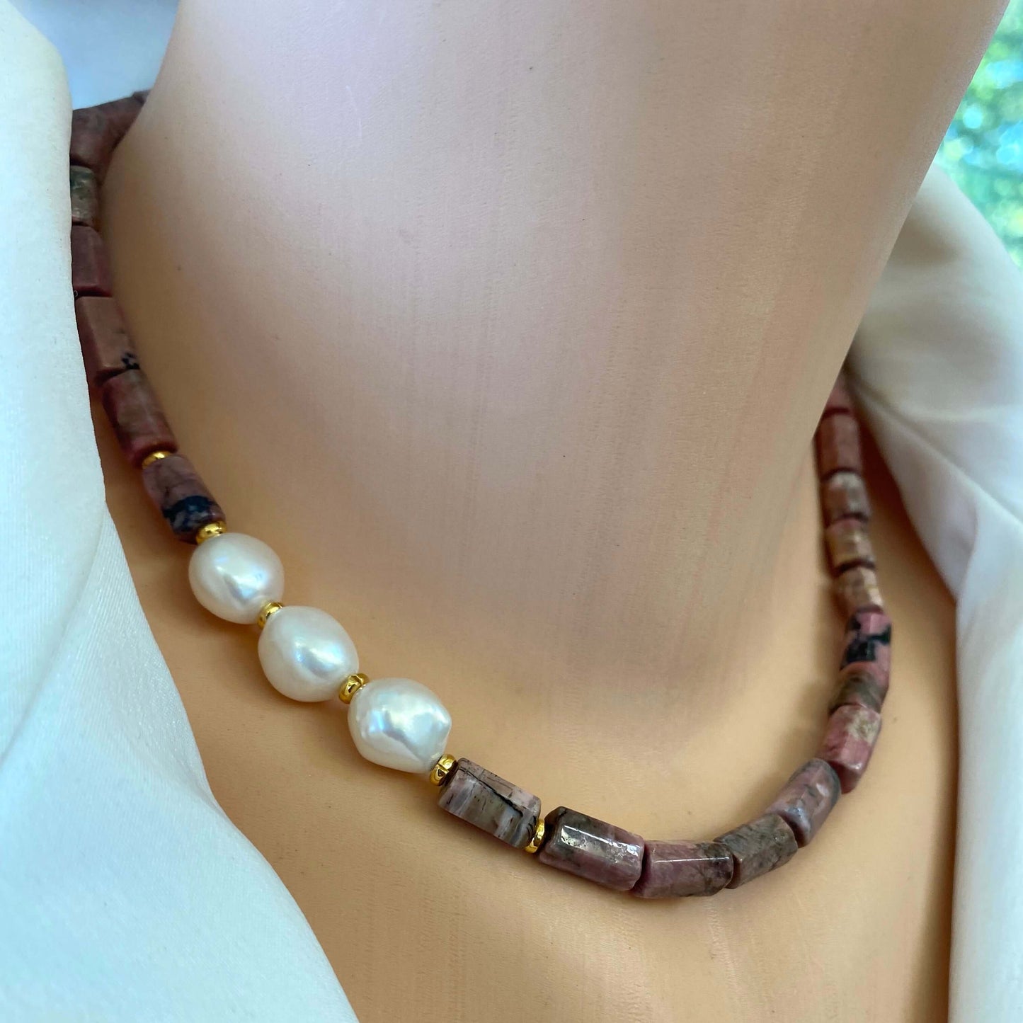 Rhodonite pearl necklace styled as an elegant gold and gemstone statement