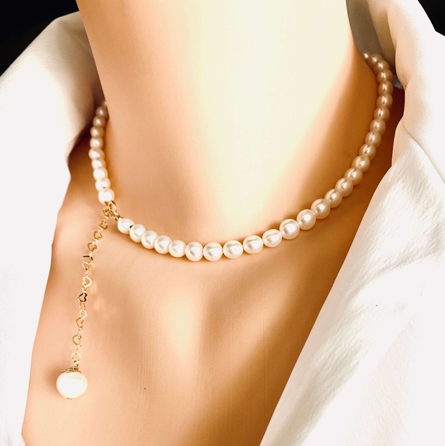 Pearl heart drop earrings worn with pearl necklace featuring gold filled heart chain