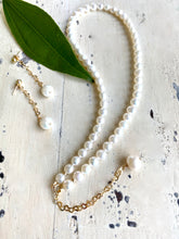 Carica l'immagine nel visualizzatore di Gallery, Classic Pearl Necklace, 15.5"inches, featuring lustrous freshwater white semi-round pearls and a delicate gold-filled heart chain extender of 7cm holding a 10mm round pearl charm. matching with it pearl earrings on heart chain drops.
