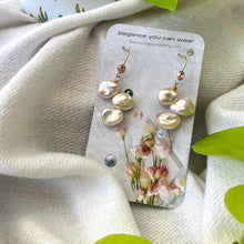 Load image into Gallery viewer, Elegant earrings composed of Natural Keshi pink and white pearls hanging from gold filled hooks with pink cubic zirconia bezel