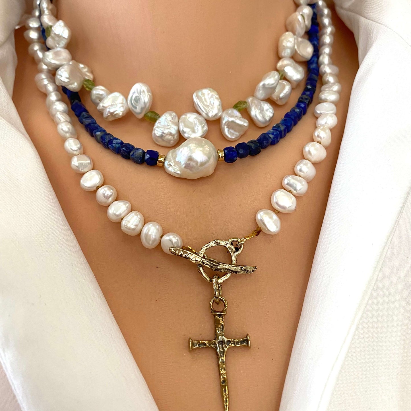 Delicate lapis lazuli baroque pearl necklace styled with layered pearl necklaces