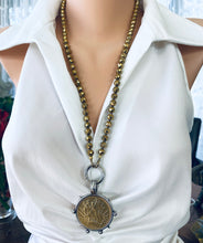 Load image into Gallery viewer, Elevate your style with this stunning Gold Faceted Hematite Beads 8mm and Repro Mexican Peso Coin Pendant Necklace. Featuring a unique Horse Coin Equestrian Pendant, this 28-inch hand-knotted necklace is the perfect piece to add to your collection.