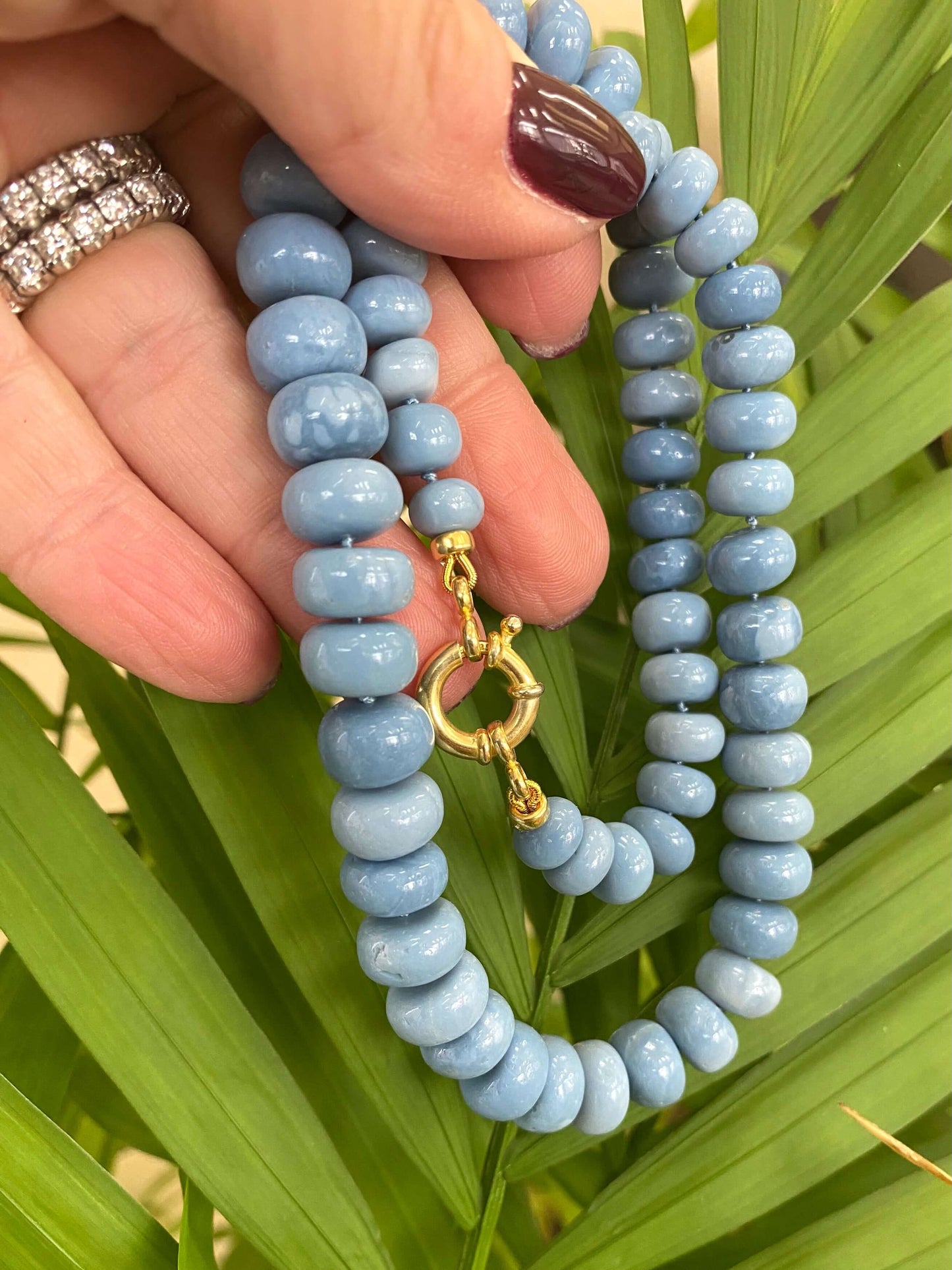 Blue opal necklace in hand, graduated Oregon blue opal rondelles and gold vermeil clasp