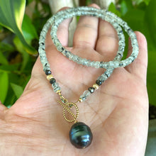 Carica l'immagine nel visualizzatore di Gallery, This necklace features a delicate chain of soft, translucent faceted green Prehnite rondelle beads, beautifully complemented by a striking Tahitian baroque pearl as the centerpiece pending from a cold filled toggle clasp. 18"inches long