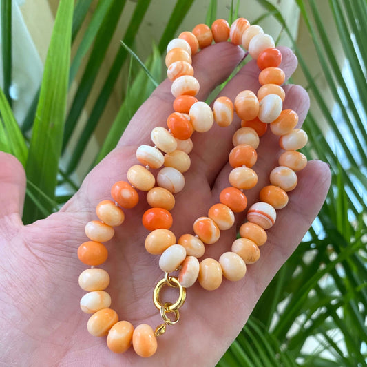 Orange opal candy necklace with rondelle beads held in hand, handmade Canadian gemstone jewelry