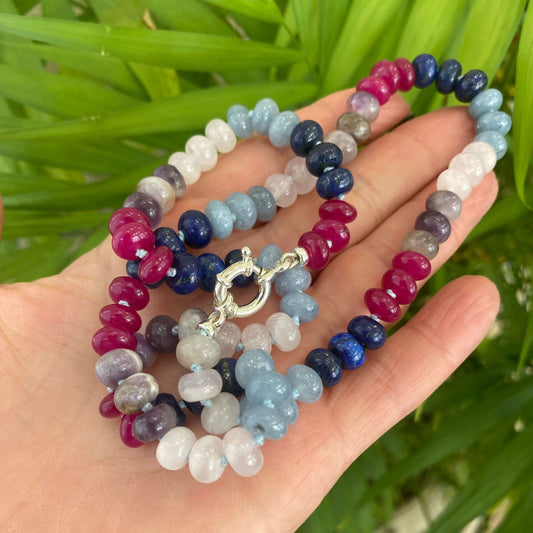 Denim candy necklace with lapis lazuli, rose quartz, and jade, showcasing colorful handcrafted beads.